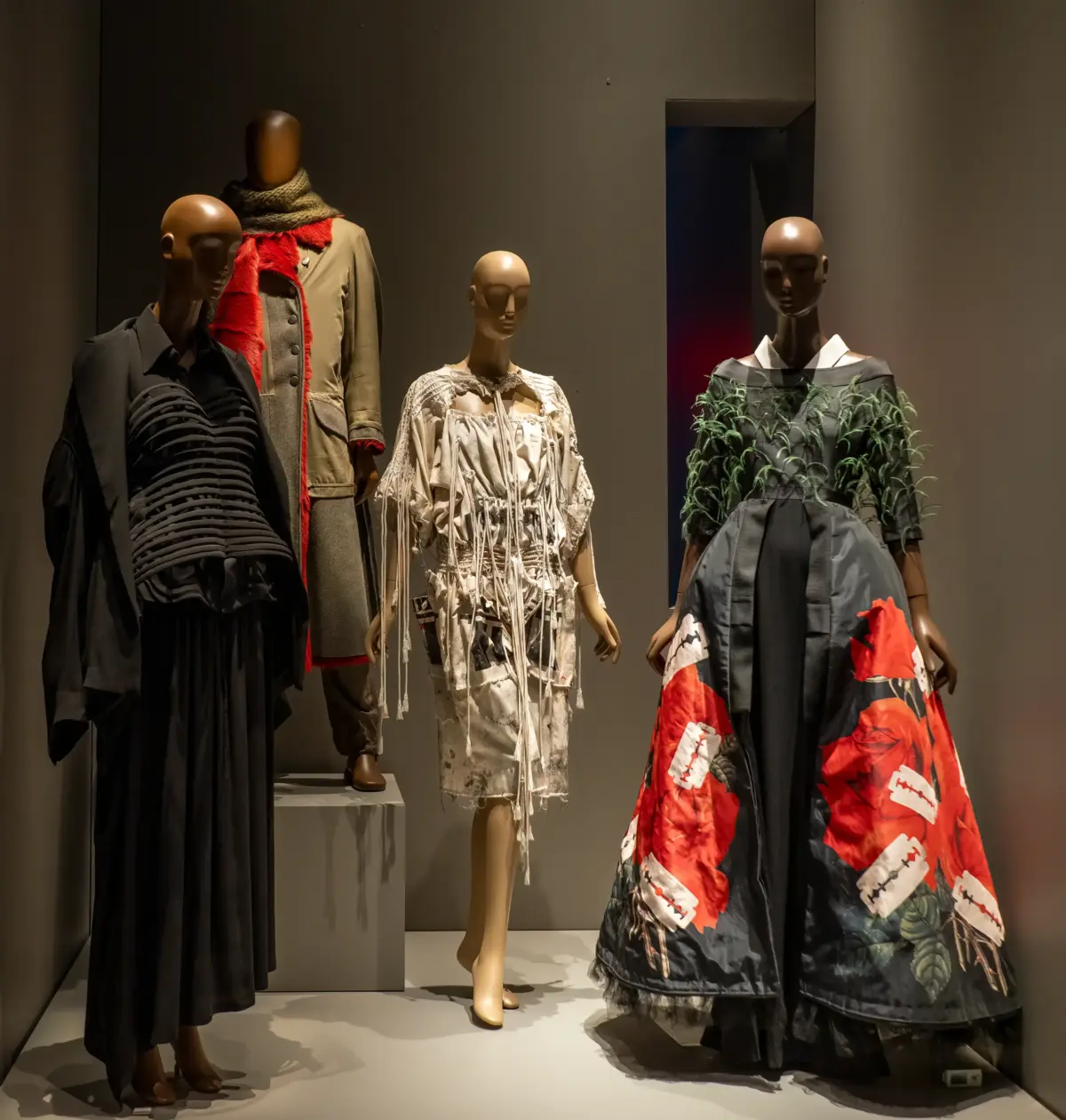 Museum exhibition featuring sculptural darkwear silhouettes and monochrome avant-garde garments at The Museum at FIT