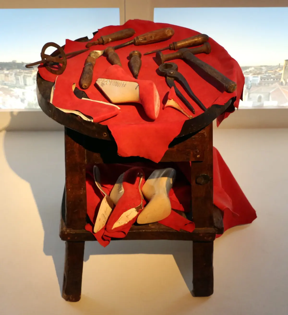 Traditional Tuscan cordwaining workbench with antique lasting tools awls leather uppers and shaping knives at Museo Salvatore Ferragamo in Florence