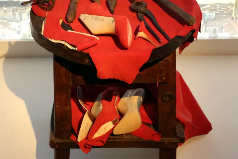 Traditional Tuscan cordwaining workbench with antique lasting tools awls leather uppers and shaping knives at Museo Salvatore Ferragamo in Florence