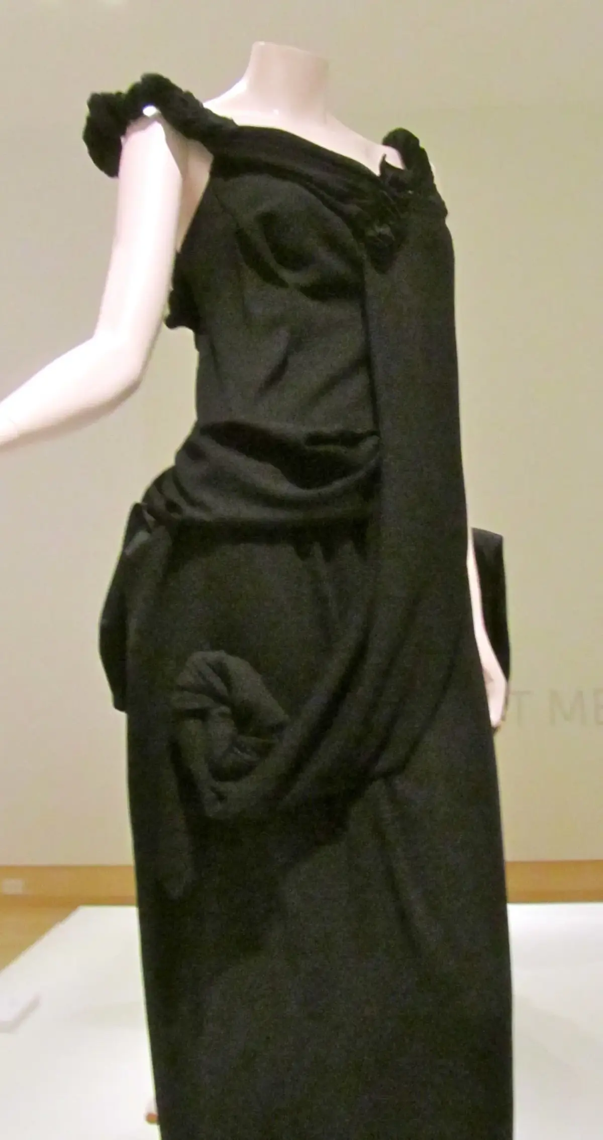 Yohji Yamamoto 1998 black draped polyester evening gown on a mannequin demonstrating asymmetrical cutting and bias drapery