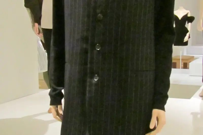Yohji Yamamoto wool suit circa 1990 displayed on a mannequin showcasing oversized proportions, dark tailoring, and fluid silhouette