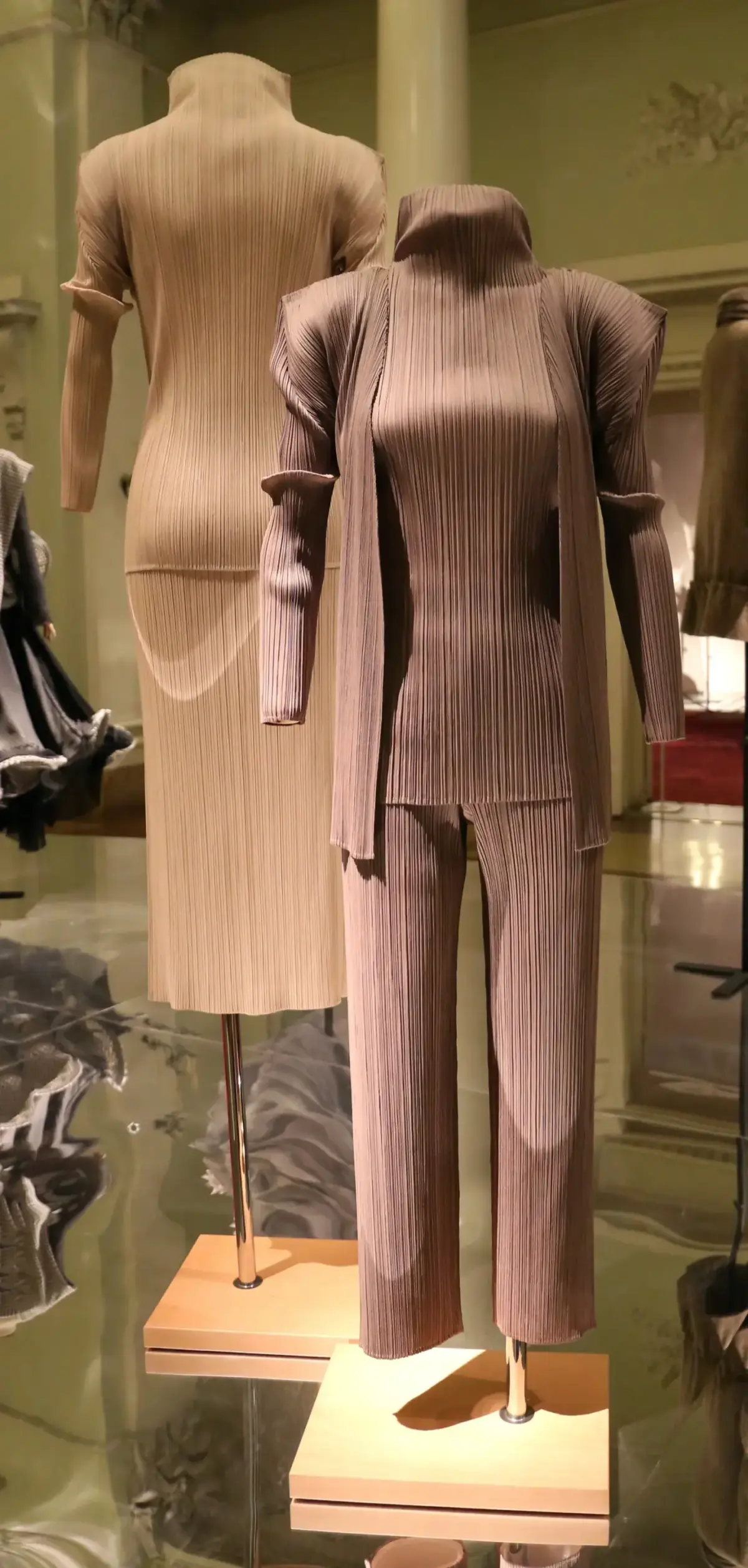 Two Pleats Please Issey Miyake pleated polyester suits displayed on mannequins at Galleria del Costume in Florence
