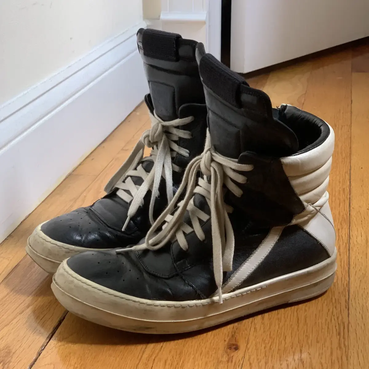 Rick Owens monochrome leather Dunk sneaker showing curved side swoop and thick rubber shark-tooth sole